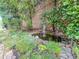 Charming backyard pond surrounded by lush greenery and a brick wall at 2826 Staunton Dr, Duluth, GA 30097