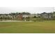 Scenic view of a pond surrounded by well-maintained lawns and various homes, perfect for relaxation and enjoyment at 2826 Staunton Dr, Duluth, GA 30097