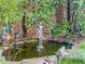 A tranquil backyard pond featuring statues and lush greenery offers a serene outdoor escape at 2826 Staunton Dr, Duluth, GA 30097