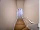 Carpeted stairway leads to light-filled upper level with hardwood floors at 2826 Staunton Dr, Duluth, GA 30097