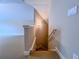 Carpeted stairway illuminated with sconce lighting transitions to a finished basement space at 2826 Staunton Dr, Duluth, GA 30097
