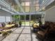Bright sunroom with glass ceiling and tiled floors is surrounded by lush greenery at 2826 Staunton Dr, Duluth, GA 30097