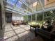 Sunroom offers tiled floor, seating, plants, and access to the backyard at 2826 Staunton Dr, Duluth, GA 30097