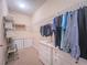 Walk-in closet with drawers, hanging clothes, carpet flooring and white walls at 2826 Staunton Dr, Duluth, GA 30097