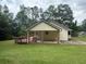 Home's backyard featuring a covered patio, brick detail, and green grass at 42 Grant Nw Dr, Cartersville, GA 30121