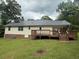 Backyard view of home, with the patio area, lawn, and natural landscape at 42 Grant Nw Dr, Cartersville, GA 30121
