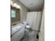 Bathroom featuring a single sink vanity with white cabinets and a shower with white curtain at 42 Grant Nw Dr, Cartersville, GA 30121