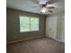 Bedroom with neutral carpet, natural light from a window, and white closet doors at 42 Grant Nw Dr, Cartersville, GA 30121