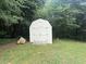 Backyard shed with double doors, concrete steps and green landscaping at 42 Grant Nw Dr, Cartersville, GA 30121