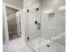 Bathroom features large shower with glass door, a shower niche, and access to a walk-in closet at 5722 Urban Village Way # 8, Tucker, GA 30084