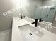 Bathroom featuring double sinks with white countertops, black faucets, and a walk-in shower with glass door at 5722 Urban Village Way # 8, Tucker, GA 30084