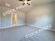 Spacious bedroom with neutral carpet, ceiling fan, high ceiling, and access to closet and bathroom at 5722 Urban Village Way # 8, Tucker, GA 30084