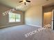 Bright bedroom with neutral carpet, a ceiling fan, a window, and an ensuite bathroom at 5722 Urban Village Way # 8, Tucker, GA 30084