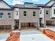 Modern townhome showcasing a brick facade, attached two-car garage, and contemporary design at 5722 Urban Village Way # 8, Tucker, GA 30084