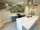 Modern kitchen features stylish gray cabinets, stainless steel appliances, and a large island with a white countertop at 5722 Urban Village Way # 8, Tucker, GA 30084