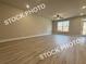 Bright living room boasting wood-look flooring and a view of the backyard through large windows at 5722 Urban Village Way # 8, Tucker, GA 30084