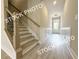 Elegant staircase design with wood treads, iron railings, and wainscoting at 5722 Urban Village Way # 8, Tucker, GA 30084