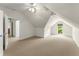 Finished attic space featuring neutral carpet and a large window, perfect for a playroom or guest room at 922 Pebblebrook Se Rd, Mableton, GA 30126
