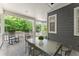 Relaxing back porch with seating, a table, and a view of the surrounding trees at 922 Pebblebrook Se Rd, Mableton, GA 30126