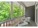 Comfortable balcony featuring outdoor seating and a wooded view at 922 Pebblebrook Se Rd, Mableton, GA 30126