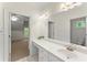 Bright bathroom featuring a large mirror, vanity with white countertop, and a view into an adjacent bedroom at 922 Pebblebrook Se Rd, Mableton, GA 30126