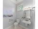 Bright half bathroom with a pedestal sink and a framed mirror at 922 Pebblebrook Se Rd, Mableton, GA 30126