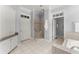 Open bathroom layout with walk-in shower, toilet, and white tiled floor at 922 Pebblebrook Se Rd, Mableton, GA 30126