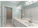 Stylish bathroom with double sinks, large mirrors, and access to a shower and tub at 922 Pebblebrook Se Rd, Mableton, GA 30126