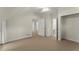 Spacious carpeted bedroom includes multiple doorways, a ceiling fan and neutral decor at 922 Pebblebrook Se Rd, Mableton, GA 30126