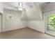 Bedroom featuring neutral carpeting, a ceiling fan, and a door leading to a balcony overlooking trees at 922 Pebblebrook Se Rd, Mableton, GA 30126