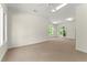 Bright bonus room with neutral carpet, recessed lighting, ceiling fan and oversized windows at 922 Pebblebrook Se Rd, Mableton, GA 30126