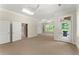 Spacious bonus room with neutral carpet, recessed lighting, ceiling fans, and multiple doors at 922 Pebblebrook Se Rd, Mableton, GA 30126