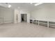 Unstaged bonus room with tile floors, recessed lighting, sink, and access to stairs at 922 Pebblebrook Se Rd, Mableton, GA 30126