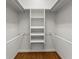 Walk-in closet with hardwood floor and custom shelving at 922 Pebblebrook Se Rd, Mableton, GA 30126