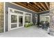 Covered patio with stone columns offers an inviting outdoor space with seating, exposed beams, and natural light at 922 Pebblebrook Se Rd, Mableton, GA 30126