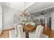 Dining room with a rustic wood table, natural light, and modern chandelier at 922 Pebblebrook Se Rd, Mableton, GA 30126