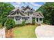 Beautifully landscaped home with a gray exterior, complemented by lush greenery and a winding driveway at 922 Pebblebrook Se Rd, Mableton, GA 30126