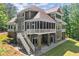 Beautiful home with screened porches, stone accents, and lush landscaping offers luxurious outdoor living at 922 Pebblebrook Se Rd, Mableton, GA 30126