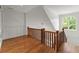 Hallway with wooden floors, decorative wainscoting, and a wooden railing, creating an inviting and stylish transition space at 922 Pebblebrook Se Rd, Mableton, GA 30126