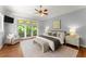 Large main bedroom offers hardwood floors, ceiling fan, and balcony access at 922 Pebblebrook Se Rd, Mableton, GA 30126