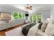 Comfortable primary bedroom with hardwood floors, large windows, and a ceiling fan at 922 Pebblebrook Se Rd, Mableton, GA 30126