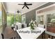 Spacious screened-in porch with wood-look trim, seating, and double doors to the interior at 922 Pebblebrook Se Rd, Mableton, GA 30126