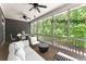 Screened-in porch with ceiling fans, plenty of seating, and beautiful views at 922 Pebblebrook Se Rd, Mableton, GA 30126