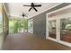 Inviting screened porch with ceiling fans, outdoor access, and serene views of the surrounding landscape at 922 Pebblebrook Se Rd, Mableton, GA 30126