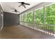 Screened-in porch with ceiling fans and great views of the surrounding greenery at 922 Pebblebrook Se Rd, Mableton, GA 30126