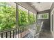 Inviting screened porch with rocking chairs, offering a peaceful retreat with scenic wooded views at 922 Pebblebrook Se Rd, Mableton, GA 30126