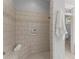 Walk-in shower with tiled walls, a built-in niche, and a comfortable bench at 922 Pebblebrook Se Rd, Mableton, GA 30126