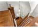 Inviting staircase featuring wood steps, banister, and white trim, with a stylish pendant light adding a touch of elegance at 922 Pebblebrook Se Rd, Mableton, GA 30126