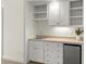 Convenient wet bar features cabinets, sink, and mini-fridge, adding convenience and style to the living space at 922 Pebblebrook Se Rd, Mableton, GA 30126