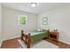 Cozy bedroom featuring hardwood floors, light walls, and a rustic wooden bed frame at 3344 Ridgecrest Dr, Powder Springs, GA 30127